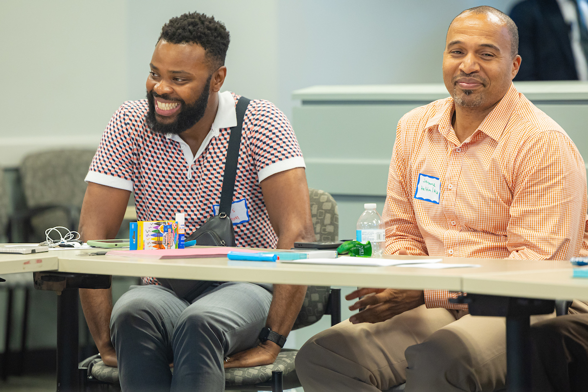 Two men laughing at round table event